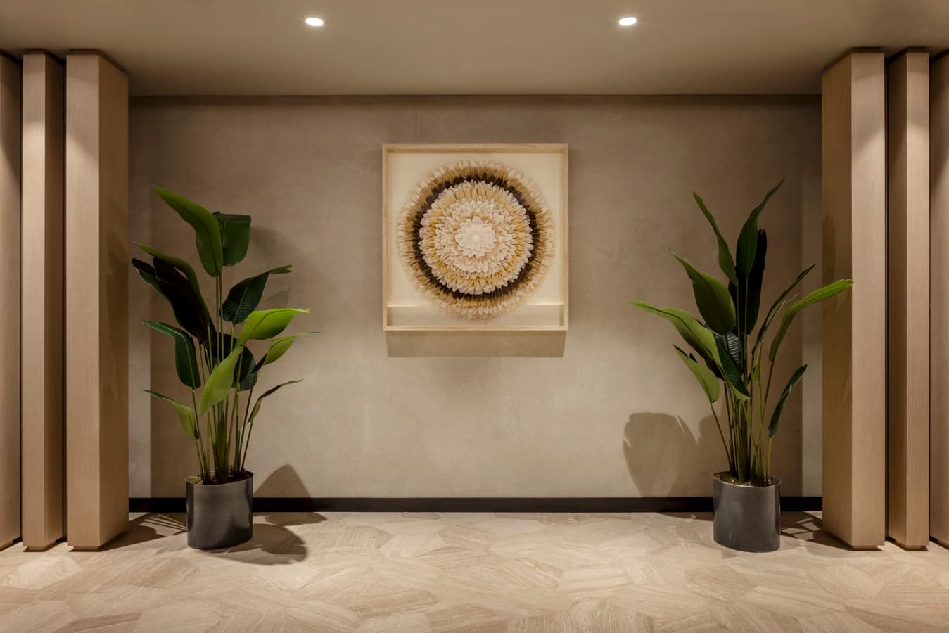 Spa corridor with framed feather artwork and green plants