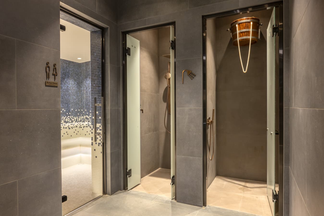 Experience showers and the bucket shower beside the mosaic steam room entrance