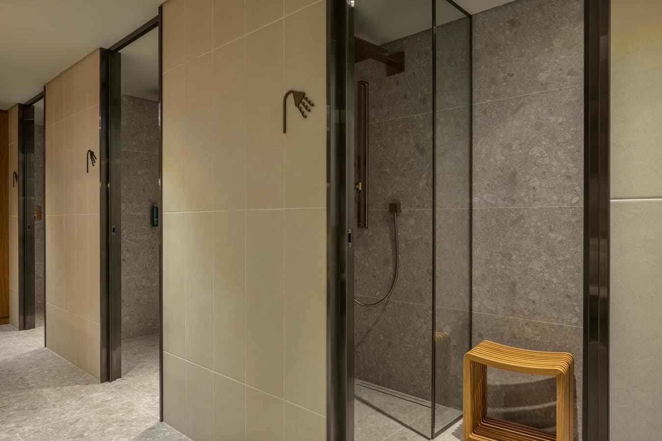 Private shower cabins in stone with bronze fittings